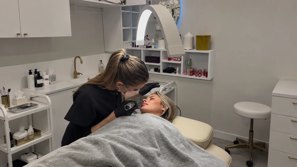 Rosie performing a permanent makeup treatment in the Tail & Blush studio